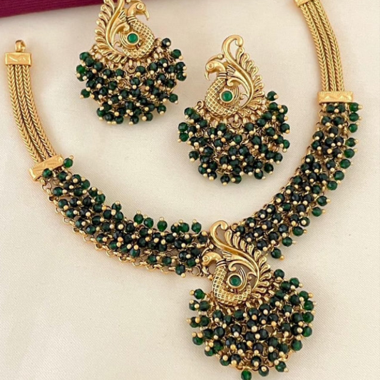 . ✨ Introducing the Peacock Royalty Set—a cascade of stunning clustered beads in your choice of Ruby Red, Lush Emerald, or Classic Pearl. This isn't just a necklace; it's a statement. Limited stock just dropped. Shop the only piece of jewelry that matters