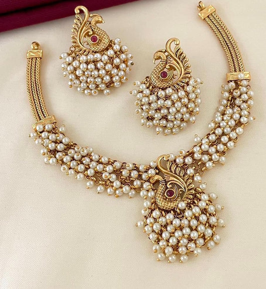"✨ Behold! Where elegance meets enchantment. ✨ Adorn yourself with this exquisite matte gold and pearl necklace set, featuring a captivating peacock design that whispers tales of timeless grace. Perfect for weddings, festivities