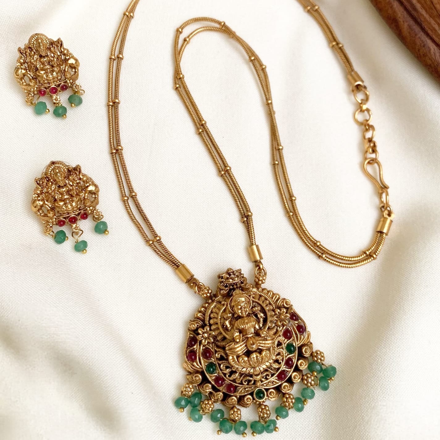 Sublime Antique Gold Lakshmi Pendant Set with Double Chain & Emerald Green Drops