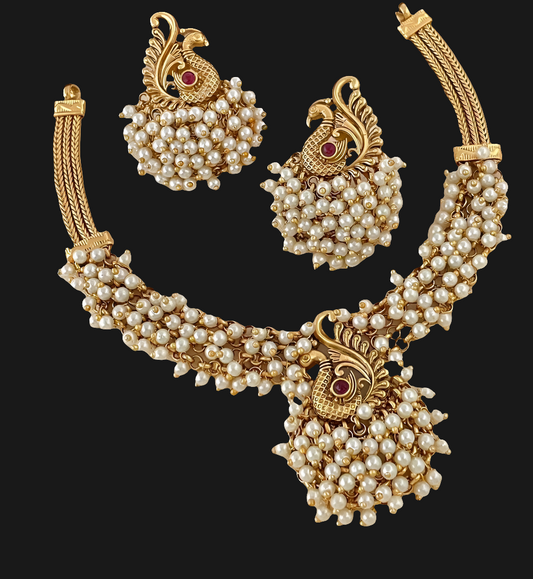 "✨ Behold! Where elegance meets enchantment. ✨ Adorn yourself with this exquisite matte gold and pearl necklace set, featuring a captivating peacock design that whispers tales of timeless grace. Perfect for weddings, festivities